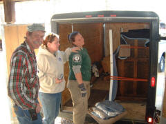 Staff members of the Bovey Restoration, Virginia and Nevada Cities, Montana preparing to remove piano from trailer: John Ellingsen (Curator of History); Janna Norby (Curator of Collections); Heather Hurd (AmeriCorps lead volunteer).