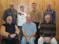 The AMICA Adopt-a-Piano team. Seated, left to right: Dick Kroeckel, Tom Zook, Don Hein. Standing: Larry and Judy Emmons, Bob Grunow, Art Reblitz.