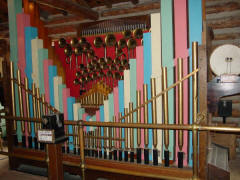 Wurlitzer 180 band organ #4,182, made in 1929. Original case, bass and accompaniment pipes (which have been unmitered!) & chest, center melody pipes & chest, stack, reservoir, duplex roll mechanism & drive and blower, with brass pipes added by Ozzie Wurdeman. N.C. Music Hall.